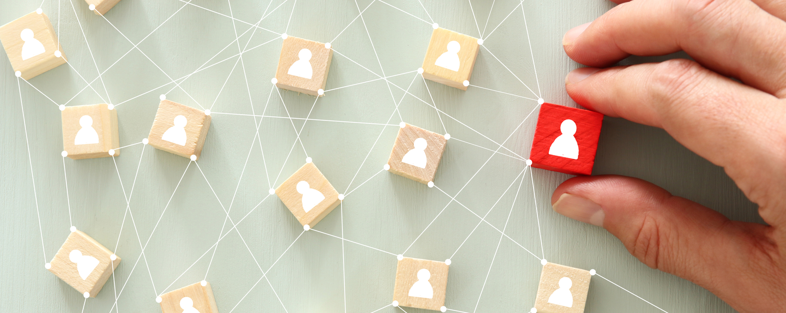 image of wooden blocks with people icon over mint table fb